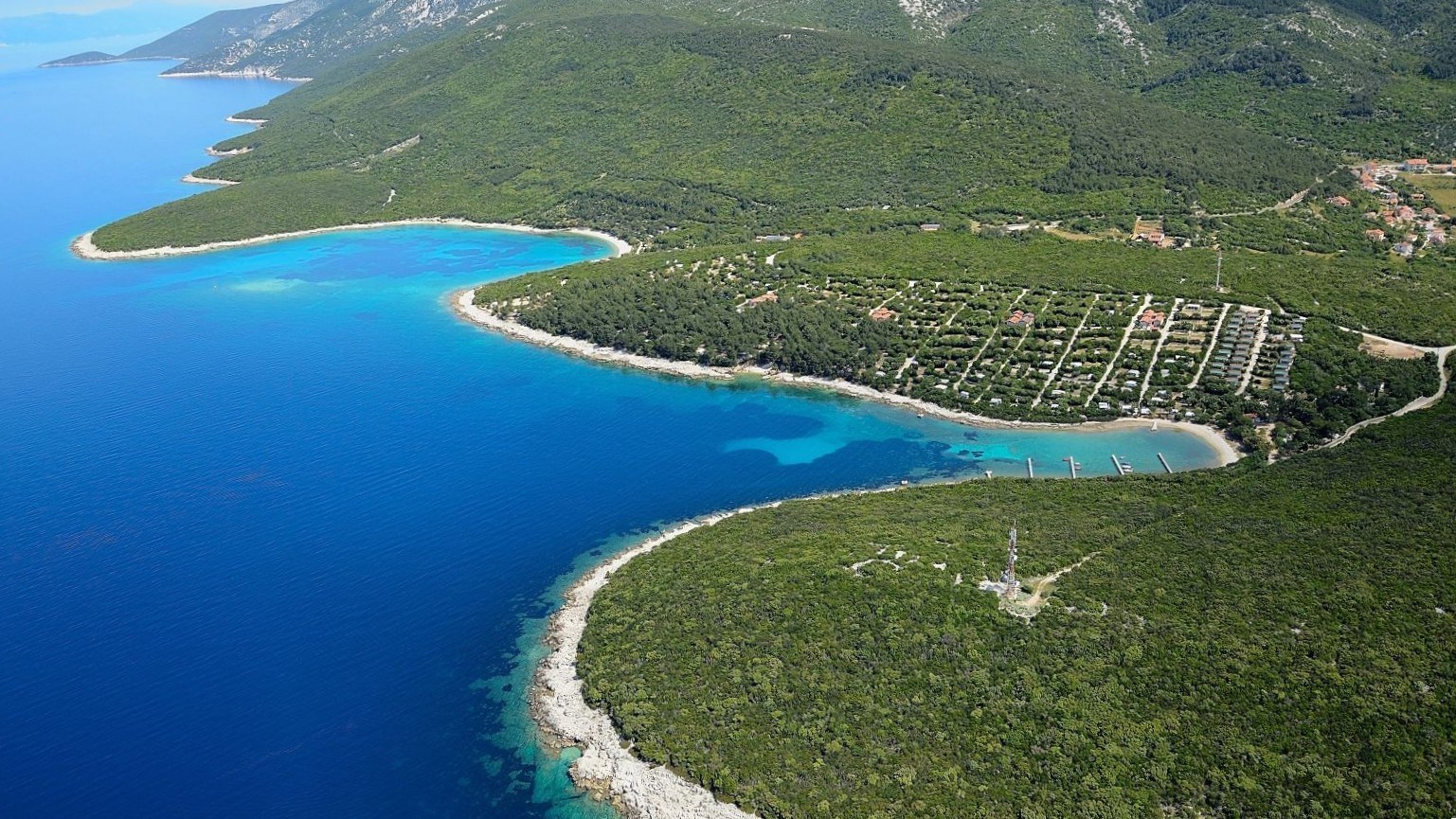 Aerial view of Camp Slatina, lush greenery and crystal-clear sea